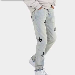 Stylish Light Blue Jeans with Black Fleur-de-Lis